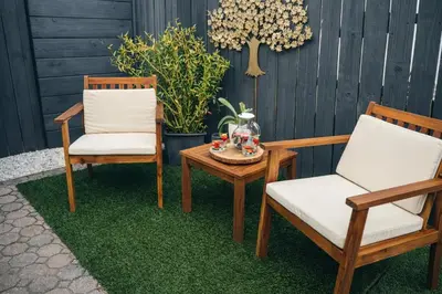 two chairs and a coffee table on a patio at Boutique Private Guest Suite with Private Entrance & Self Check In Near Hard Rock Cruise Port & FLL Airport in Fort Lauderdale