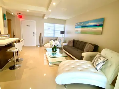 a living room with a couch and a table at Premium Modern waterfront apartment with Miami Skyline view on the bay 5 mins drive to Miami Beach with free parking in Miami Beach