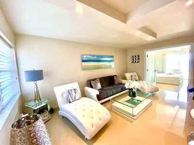 a living room with a couch and a table at Premium Modern waterfront apartment with Miami Skyline view on the bay 5 mins drive to Miami Beach with free parking in Miami Beach