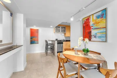 a kitchen and dining room with a table and chairs at Eternal Sunrise Suite in Fort Lauderdale