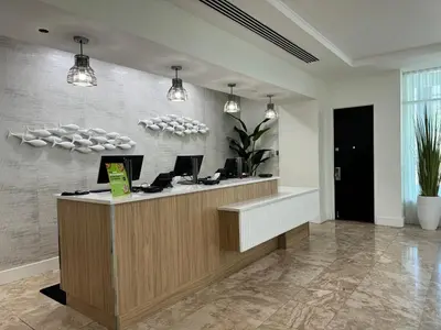 an office with a reception desk with two computers at Eternal Sunrise Suite in Fort Lauderdale