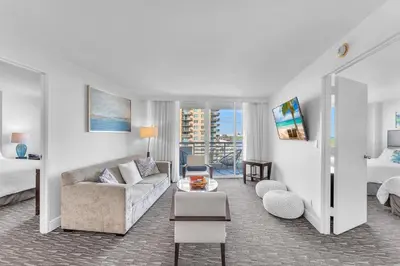 a living room with a couch and a bed at Eternal Sunrise Suite in Fort Lauderdale