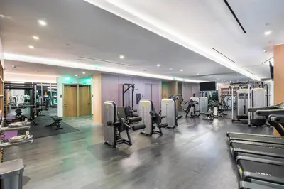 a gym with treadmills and machines in a room at Suites at SLS Lux Brickell managed by CE in Miami