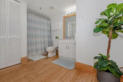 a bathroom with a toilet and a plant in it at Lovely condo with city & ocean views. Sleep up to 6 people! in Miami