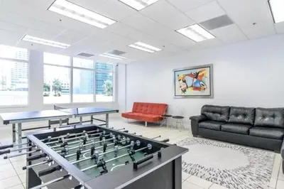 a living room with a foosball table and a couch at Lovely condo with city & ocean views. Sleep up to 6 people! in Miami
