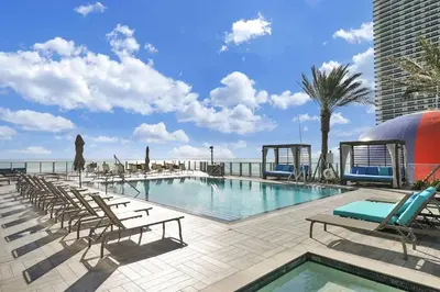 a swimming pool with chaise lounges and chairs at Ocean View Beachfront 2Bed/2B M-Penthouse @HYDE in Hollywood