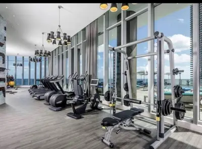 a gym with a row of treadmills and machines at Ocean View Beachfront 2Bed/2B M-Penthouse @HYDE in Hollywood