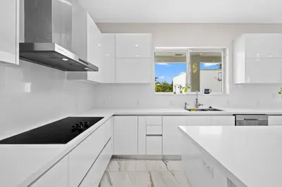 a white kitchen with white cabinets and a sink at Casa Blanca of Miami º Families & Weekly Stays Close to Miami Beaches and the Keys West in Princeton