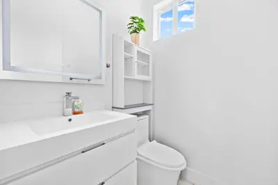 a white bathroom with a toilet and a sink at Casa Blanca of Miami º Families & Weekly Stays Close to Miami Beaches and the Keys West in Princeton