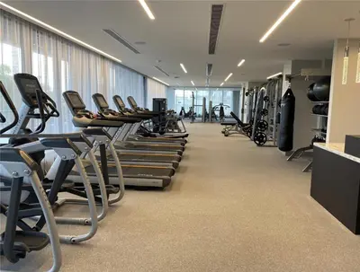 a gym with rows of exercise bikes and treadmills at DOWNTOWN DORAL, FLORIDA. NEW CONDO STYLE RESORT. in Miami