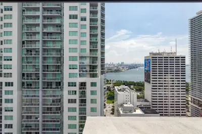 a view of a city with tall buildings and a river at Amazing Condo in Downtown Miami/Brickell w/PARKING in Miami