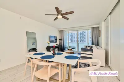 a dining room and living room with a table and chairs at 1 Bedroom with ocean and city views! in Fort Lauderdale