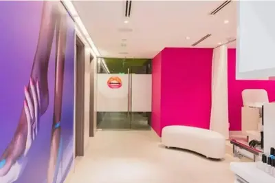 a room with pink and purple walls and a white chair at 1 Bedroom with ocean and city views! in Fort Lauderdale