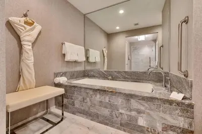 a bathroom with a large tub and a mirror at Studio Suite at Fort Lauderdale in Fort Lauderdale