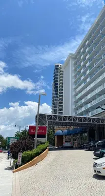a large building with a parking lot in front of it at Beachfront condo in Miami! in Sunny Isles Beach