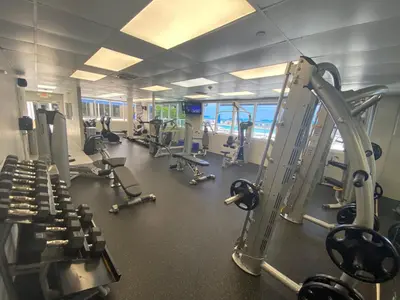a gym with several treadmills and cardio machines at Beachfront condo in Miami! in Sunny Isles Beach