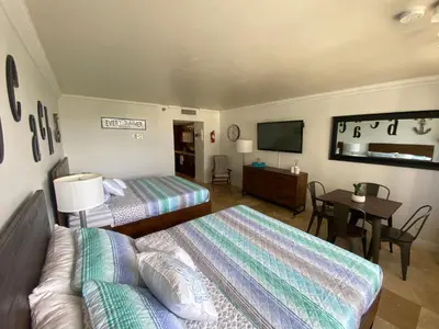 a hotel room with two beds and a television at Beachfront condo in Miami! in Sunny Isles Beach