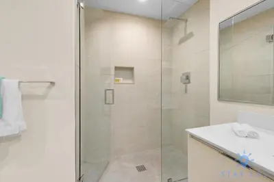 a bathroom with a shower with a glass door at Perfect Relax - Rooftop Pool - Gym - Hot Tub in Hollywood