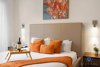 a bedroom with a bed with orange pillows at Perfect Relax - Rooftop Pool - Gym - Hot Tub in Hollywood