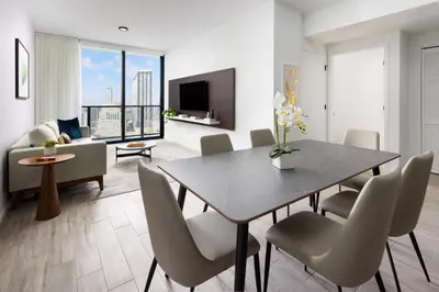 a dining room with a table and chairs and a couch at The Elser Hotel Miami - An All-Suite Hotel in Miami
