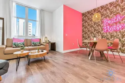 a living room with a couch and a table at Cozy Apartment - Hot Tub - NearBeach - Broad - walk in Hollywood