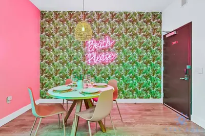 a dining room with a table and chairs in front of a wall at Cozy Apartment - Hot Tub - NearBeach - Broad - walk in Hollywood