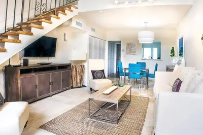 a living room with a couch and a table at Villa at St. James Place “H”, Luxury, Pet Friendly in Miami