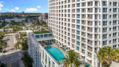 an aerial view of a large white building with a pool at Stylish 1 BR at Fort Lauderdale in Fort Lauderdale
