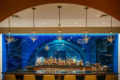 a bar with a blue wall and chandeliers at Stylish 1 BR at Fort Lauderdale in Fort Lauderdale