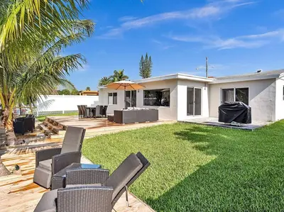 a yard with chairs and a house at 5-star Lakefront Oasis In Hollywood-Hard rock casino in Fort Lauderdale