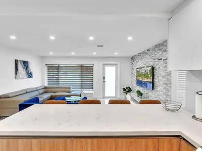 a kitchen and living room with a table and chairs at 5-star Lakefront Oasis In Hollywood-Hard rock casino in Fort Lauderdale