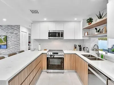 a kitchen with white counters and a stove top oven at 5-star Lakefront Oasis In Hollywood-Hard rock casino in Fort Lauderdale