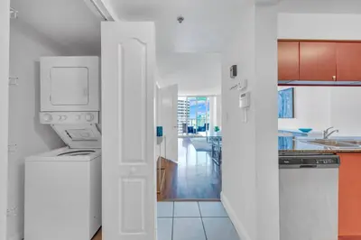 a white kitchen with a sink and a dishwasher at 40th floor Ocean View - Best Location in Miami