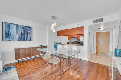 a dining room and kitchen with a glass table and chairs at 40th floor Ocean View - Best Location in Miami