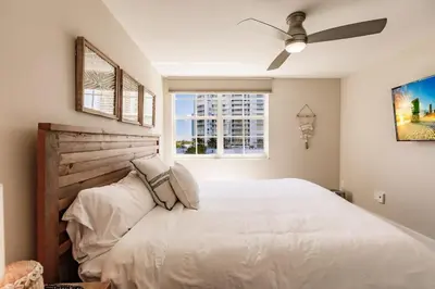 a bedroom with a white bed and a window at Uhost AI - 3BR Condo - Stunning Water Views in Miami