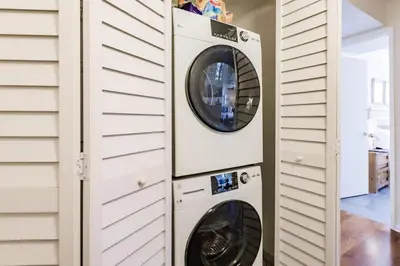 two washer and dryer units in a house at Uhost AI - 3BR Condo - Stunning Water Views in Miami