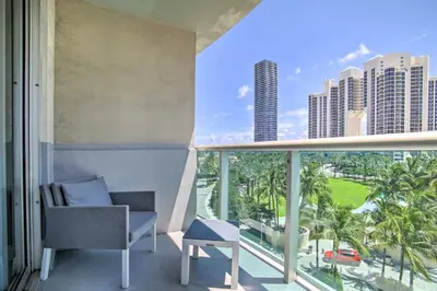 a balcony with a chair and a view of the city at Less Than Half-Mi to Beach Sunny Isles Resort Condo in Miami Beach