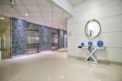 a hallway with a mirror and blue vases on a table at Less Than Half-Mi to Beach Sunny Isles Resort Condo in Miami Beach