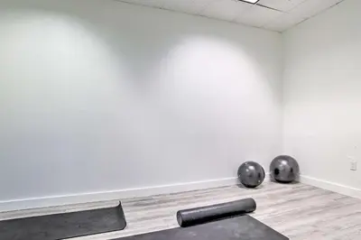 an empty room with two metal objects on the floor at Less Than Half-Mi to Beach Sunny Isles Resort Condo in Miami Beach