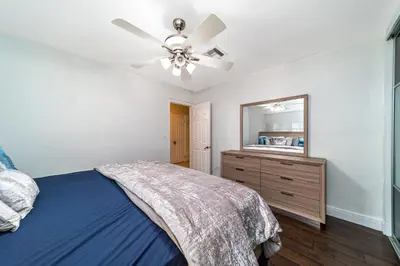 a bedroom with a bed and a ceiling fan at Pool House on the Water 2 in Miami