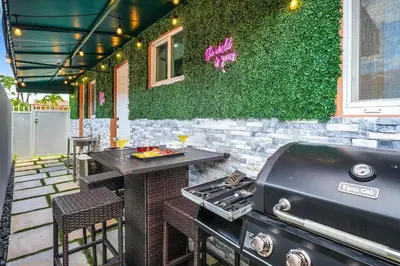 a grill and a table on a patio at Vacay Spot Happy Escape 15 Min Beach Massage Shower Prime LOC! 6 blocks away from Bars, Nite Clubs, Res, Shops in Miami