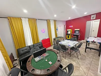 a room with a table with a laptop on it at Vacay Spot Gables 4 to 23 Guest GameRoom 2 Kitchens 2 BBQ, 2 BAR, Backyard, Patio, Prime LOC! 6 blocks away from Bars, Nite Clubs, Res, Shops in Miami