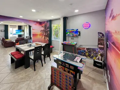 a childrens play room with a table and a video game at Vacay Spot Gables 4 to 23 Guest GameRoom 2 Kitchens 2 BBQ, 2 BAR, Backyard, Patio, Prime LOC! 6 blocks away from Bars, Nite Clubs, Res, Shops in Miami