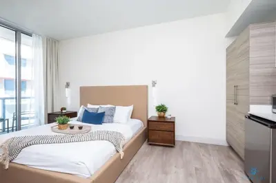 a bedroom with a large bed and a kitchen at Rooftop infinity Pool - Hollywood Beach Broad - walk in Hollywood