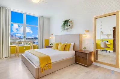 a bedroom with a large bed and a large mirror at Hollywood Beach Broad - walk - Gym - Amazing Pool in Hollywood