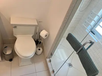 a bathroom with a toilet and a glass shower at Direct Ocean View - Luxurious condo in South Beach in Miami Beach