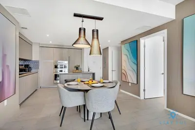 a kitchen and dining room with a table and chairs at Sophisticated Coastal Haven, Parking Included in Hollywood