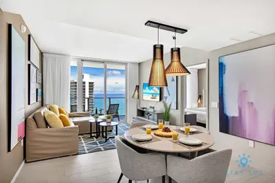 a living room and dining room with a table and chairs at Sophisticated Coastal Haven, Parking Included in Hollywood