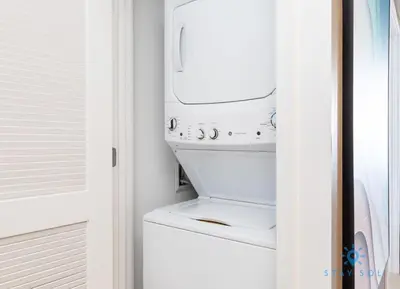a white washer and dryer in a laundry room at Sophisticated Coastal Haven, Parking Included in Hollywood
