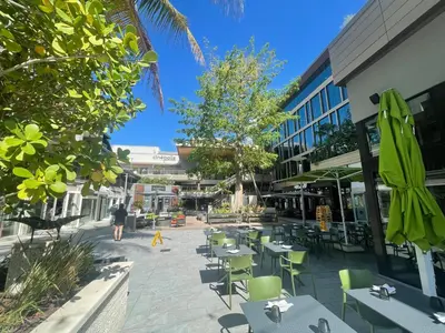 a courtyard with tables and chairs in a building at Key West Style Historic Home in Coconut Grove Florida The Yellow House in Miami
